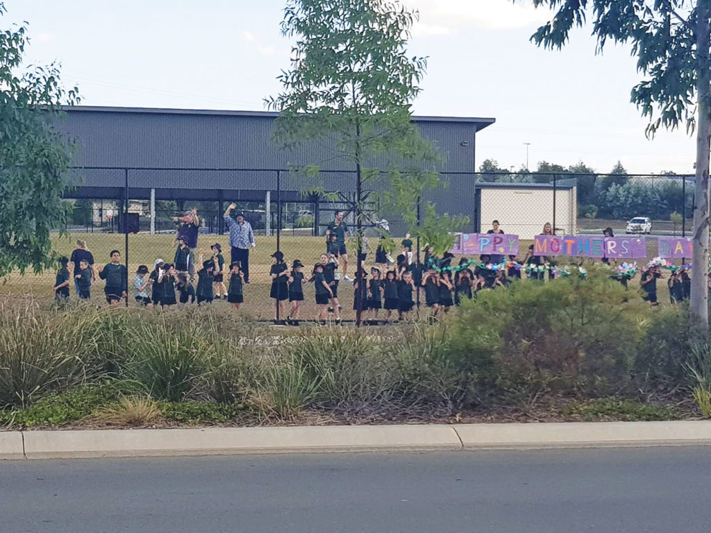 Children at St Clare’s Primary School with a Mum's Day Sign