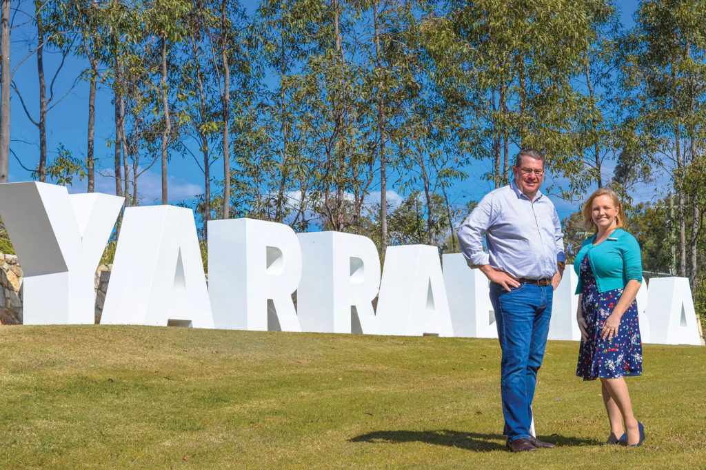 Scott Buchholz and Laurie Koranski in front of Yarrabilba sign