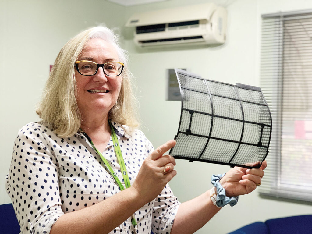 Rose holding a clean air conditioner filter