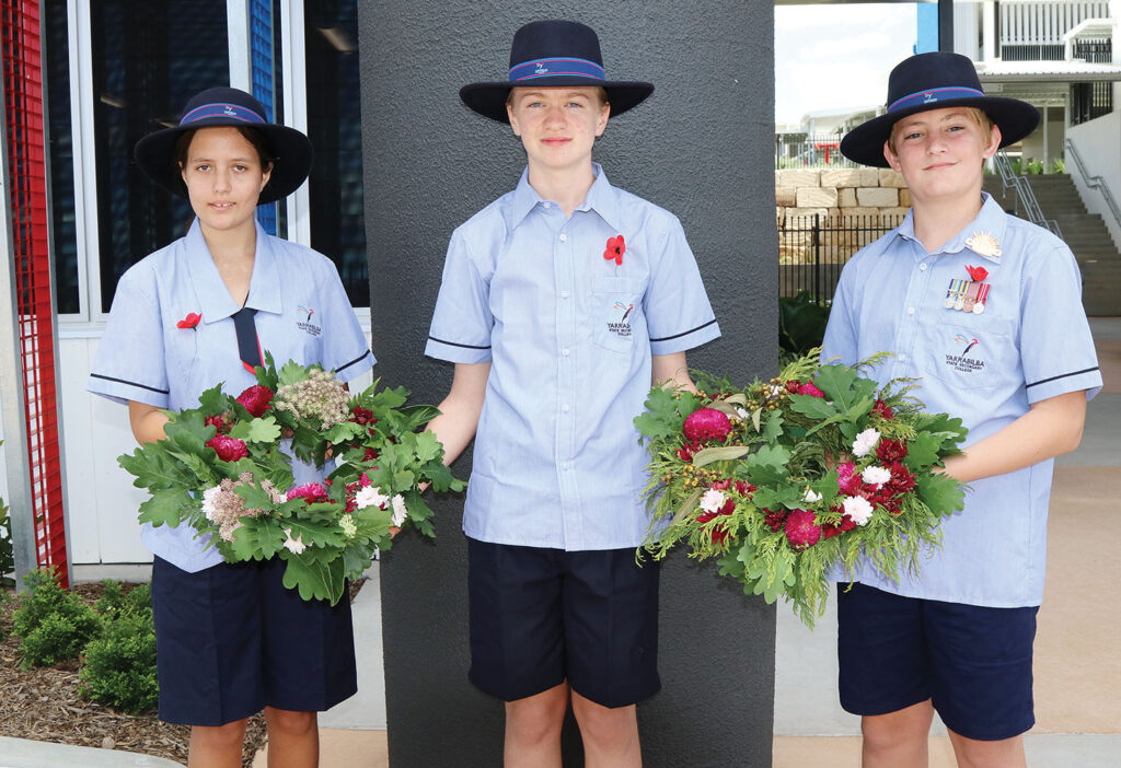 Students laying wreaths