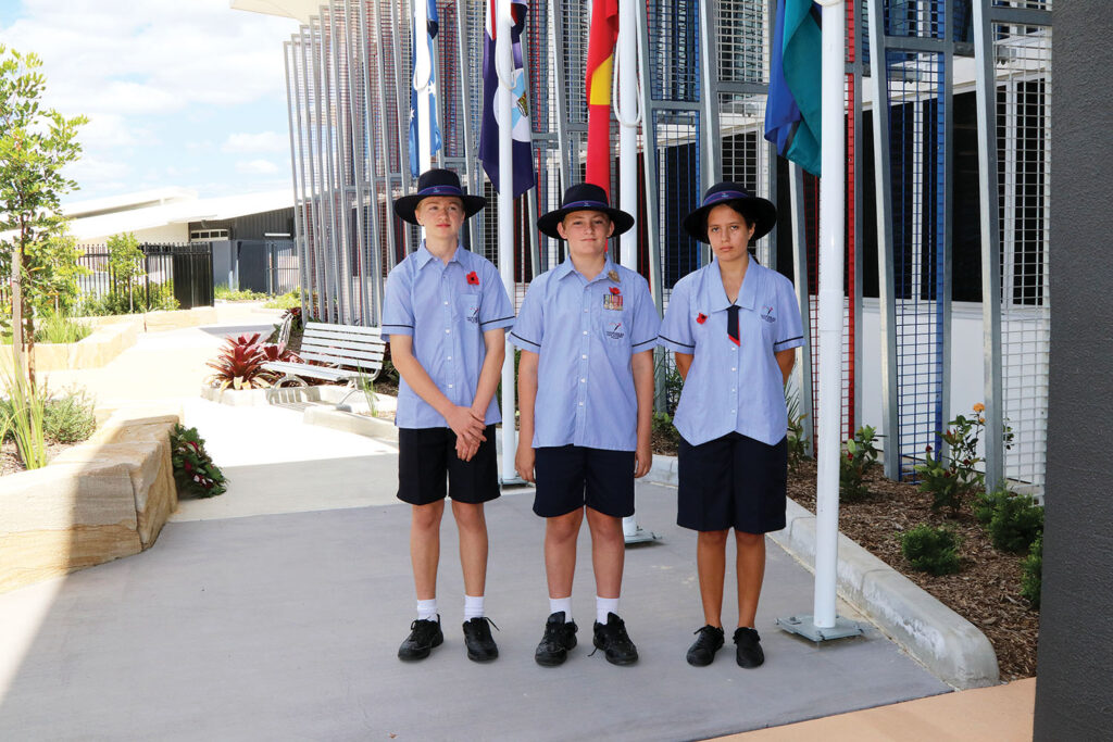 Students lowering flags