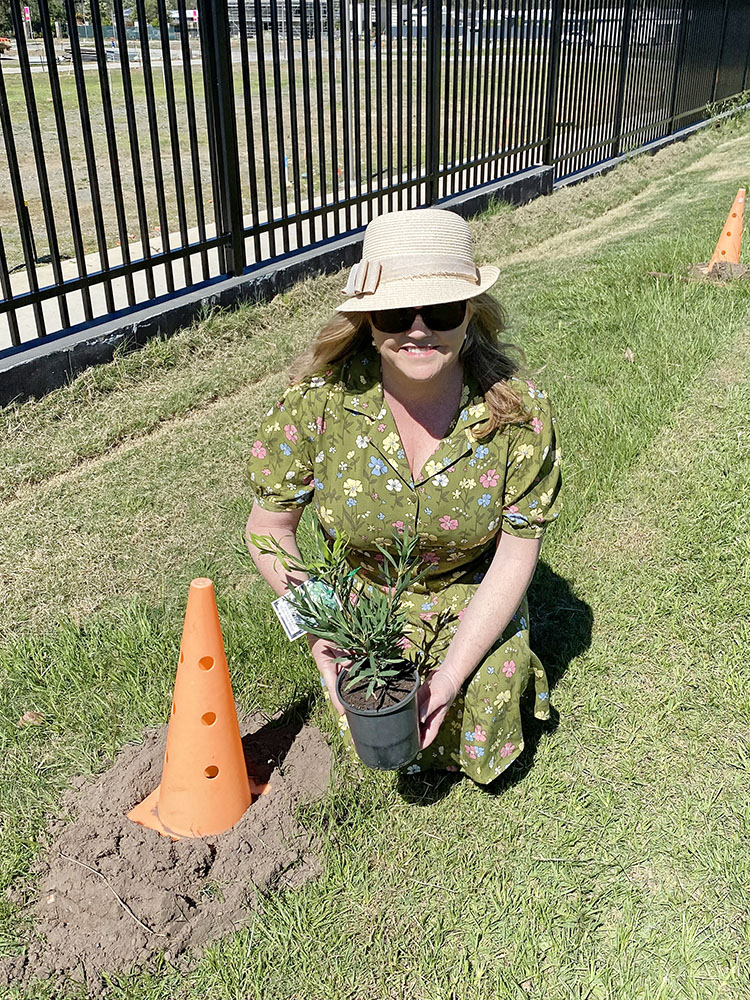 Cr Laurie Koranski planting a native tree