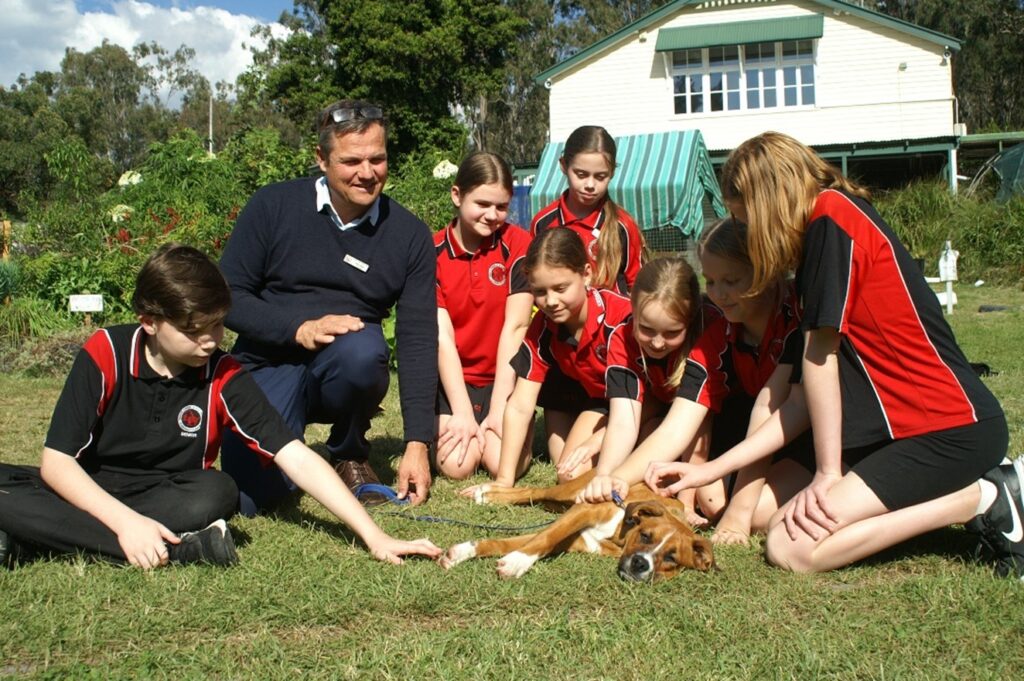 Principal Mike Meier and students with Albi at Cedar Creek State School