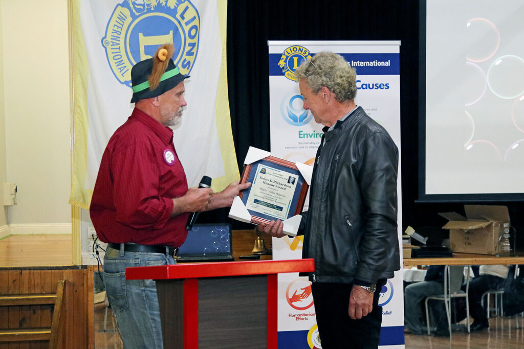 Lion John is presented with his James D Richardson Award from President Lion Phil