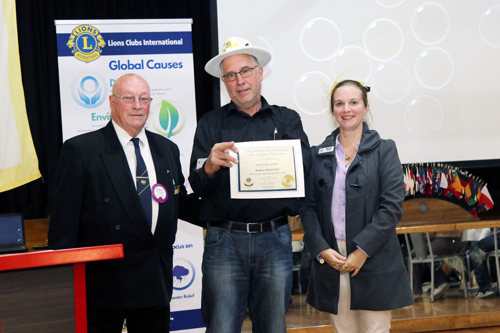 (L-R) Lion Bob (founding member) Life Membership recipient: Brad IPDG – Nicole – Presenter